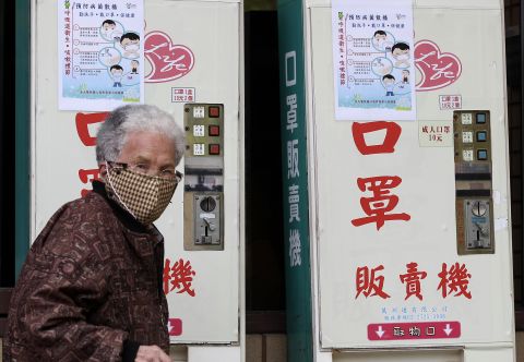 A woman wearing a medical mask walks past vending machines that sell masks outside National Taiwan University Hospital in Taipei on April 26. A 53-year-old Taiwanese businessman has contracted the H7N9 strain of bird flu while traveling in China, Taiwan's Health Department said on April 24. It's the first reported case outside of mainland China. The man was hospitalized after becoming ill three days after returning from Suzhou on April 9.