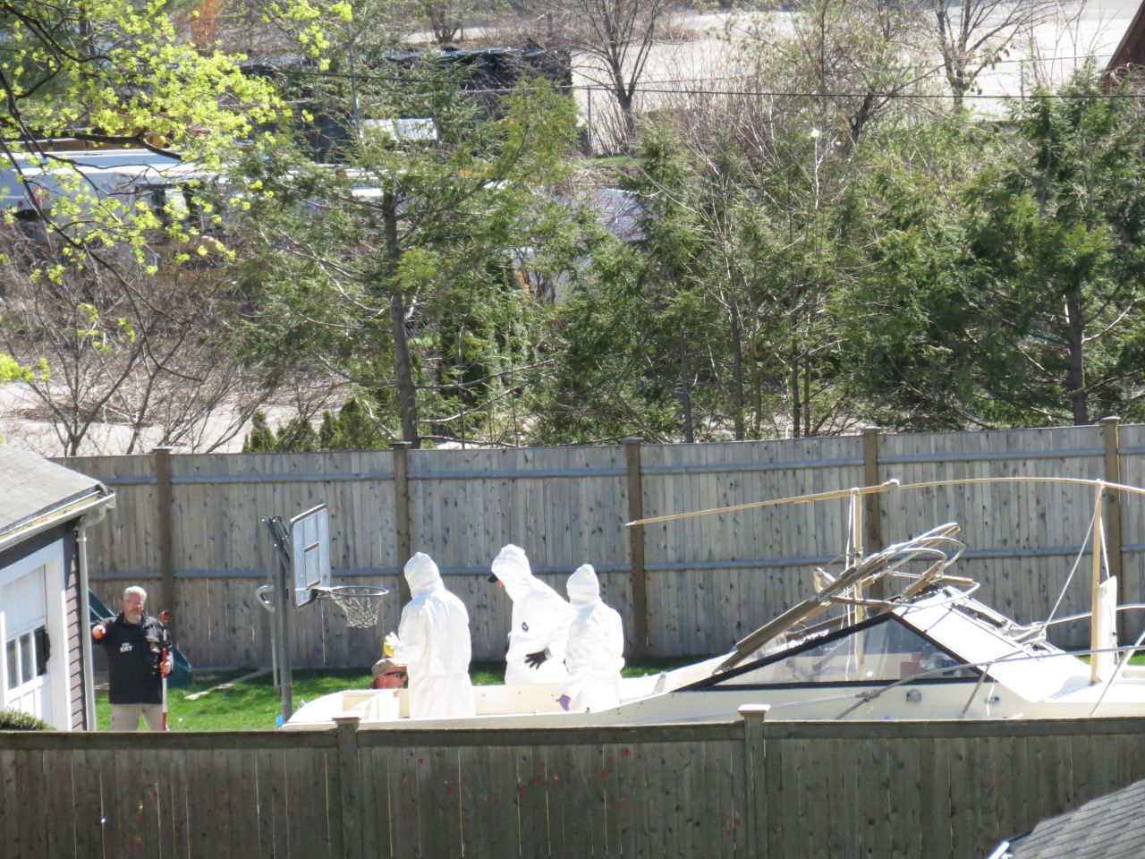 A police forensics team examines a boat April 22, 2013, in Watertown, Massachusetts, where Boston Marathon bombing suspect Dzhokhar Tsarnaev was discovered several days earlier and taken into custody.