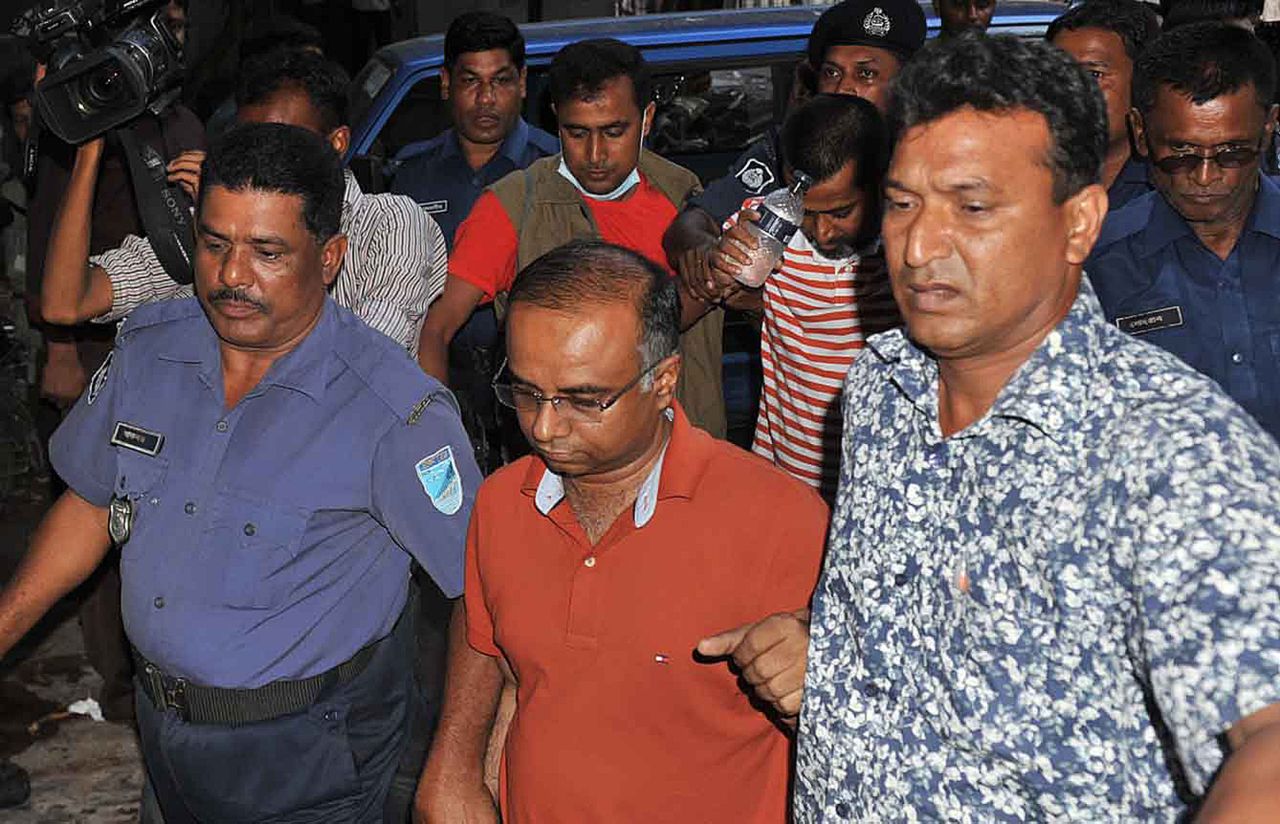 An arrested owner of a garment factory is escorted to an appearance at the court in Dhaka on April 27. Four people were arrested and four others are being questioned by police.