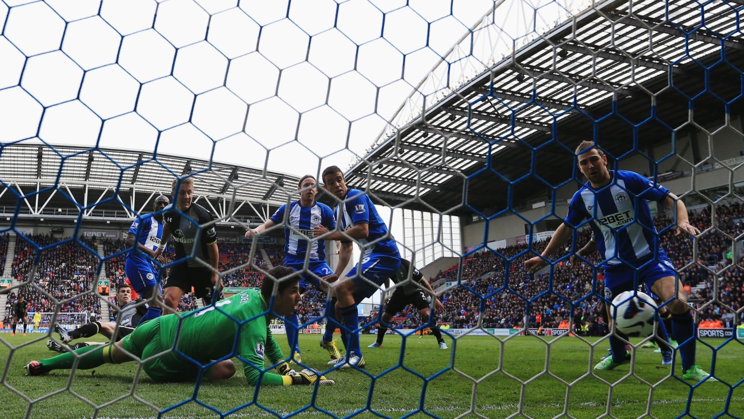 Wigan's Emmerson Boyce (2nd left) concedes an own goal against Tottenham Hotspur at the DW Stadium. 