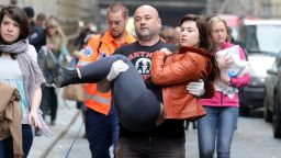 A man carries a young woman injured by a powerful gas blast in Prague's historic center on April 29, 2013.