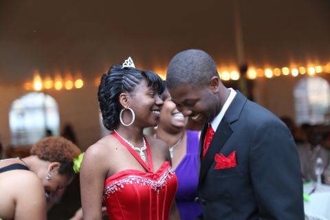 Mareshia Rucker, one of the 2013 prom organizers, wore a long, red gown and a small tiara in her hair. Her date, Mercer University student Arkel Bennett, wore a matching vest and tie. Mareshia's grandmother has sewn formal dresses for her to wear to the JROTC ball in the past. For the 2013 dance, her dress was donated.