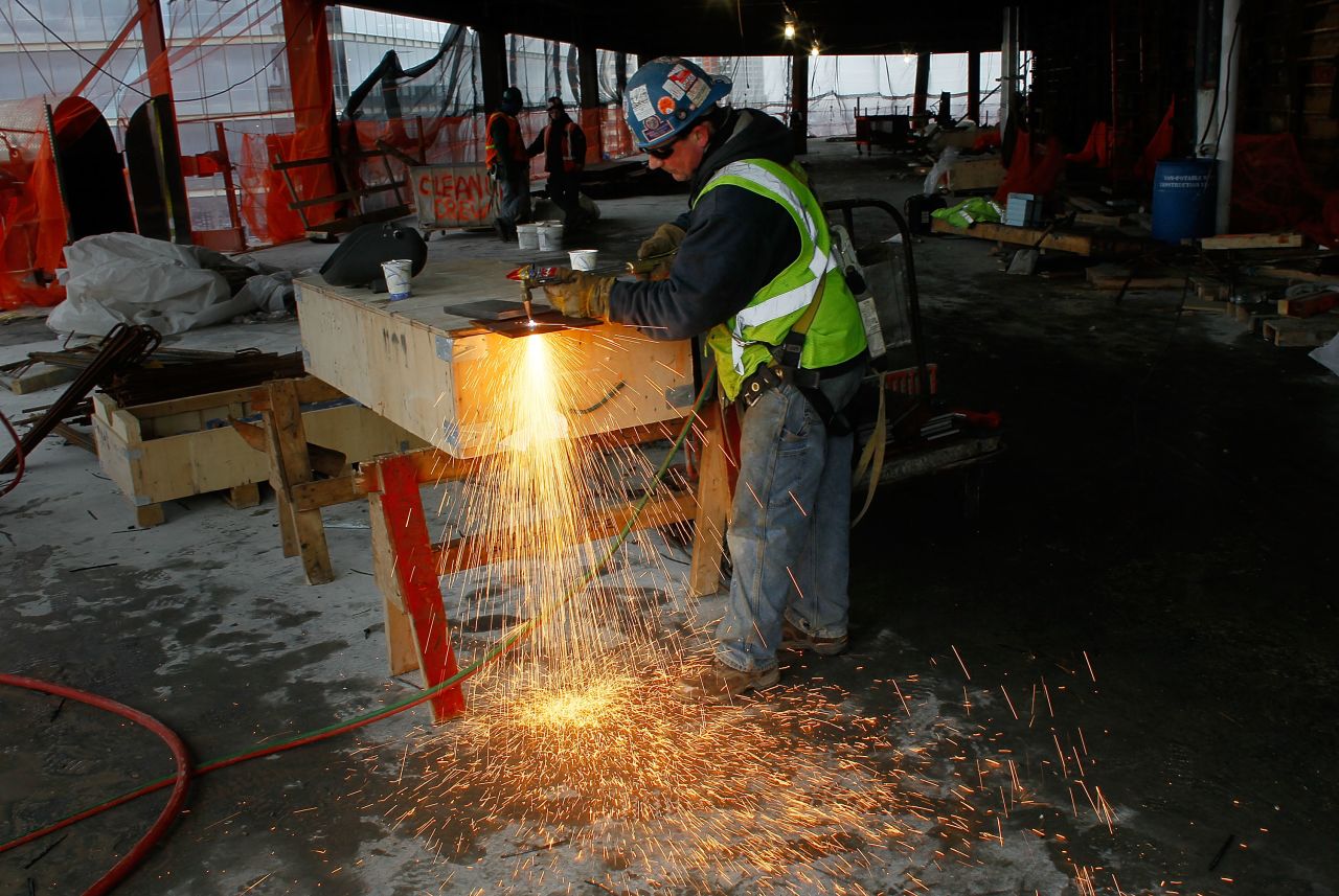 A worker uses a blowtorch to cut metal near the temporary top floor of One World Trade Center on March 9, 2011.