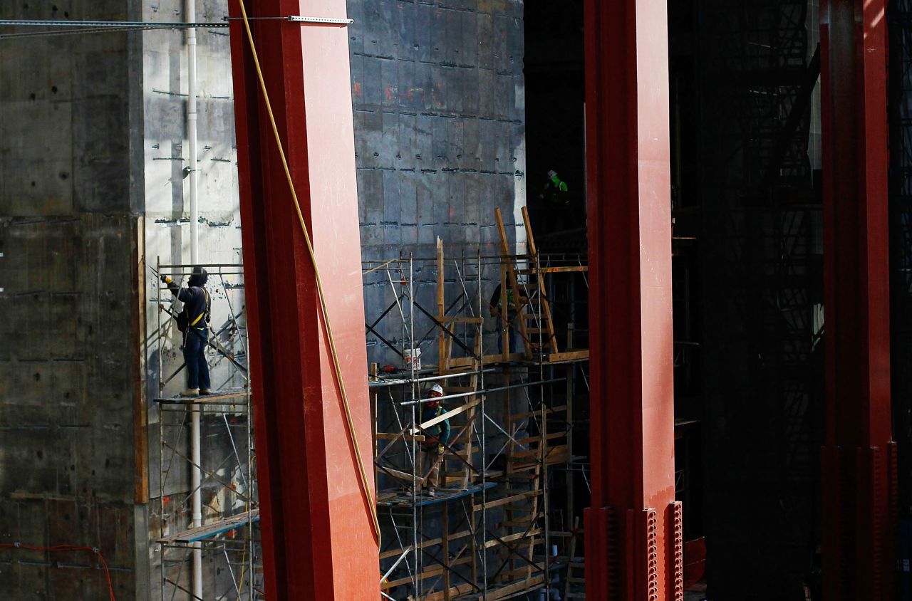 A worker stands on a scaffolding near the base of the construction on December 9, 2010.