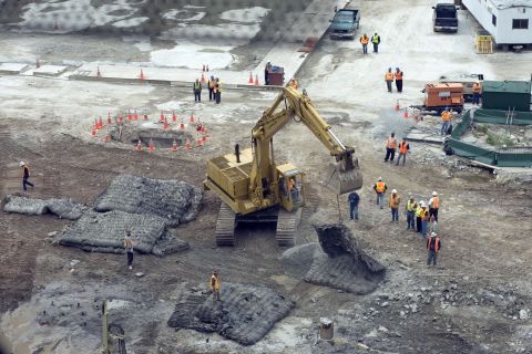 An excavator moves protective mats into position over the hole where test blasts were fired in preparation for the footings of what was then called Freedom Tower on June 12, 2006.