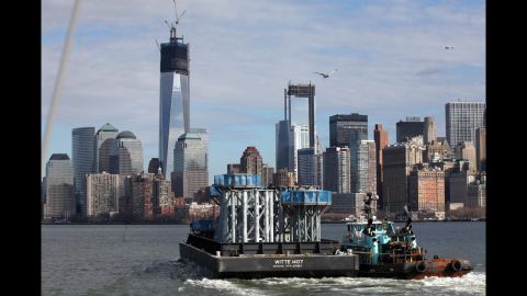 Parts of the spire for the new skyscraper make their way on a barge from Port Newark to Lower Manhattan on December 11.
