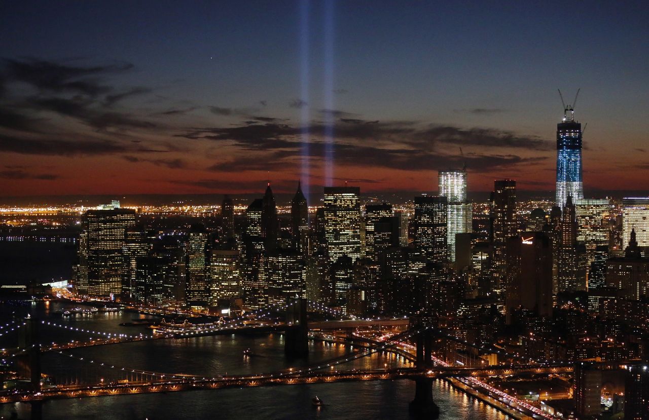 The "Tribute in Light" shines near the spots where the twin towers once stood as red, white and blue light up the new building on the 11th anniversary of the attacks.