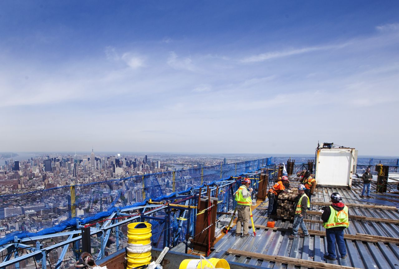 Ironworkers walk around the steel decking on the 100th story of the building on April 12, 2012.