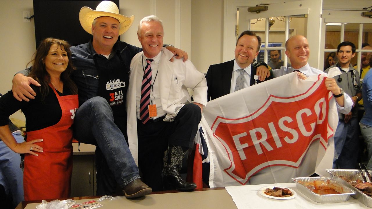 Trace Arnold brings barbecue to Massachusetts General Hospital in Boston on April 23 after staff there sent food to a hospital in Texas. Arnold, second from left, runs the 3 Stacks Smoke & Tap House in Frisco, Texas.