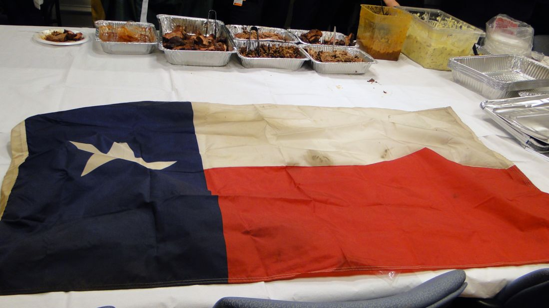 Arnold gave this Texas flag, which he retired from his mobile smoker, to Kabrhel.