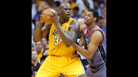 With the New Jersey Nets, Collins guards the Lakers' Shaquille O'Neal in 2002 in Los Angeles. Collins played for the Nets from 2002 through 2008.