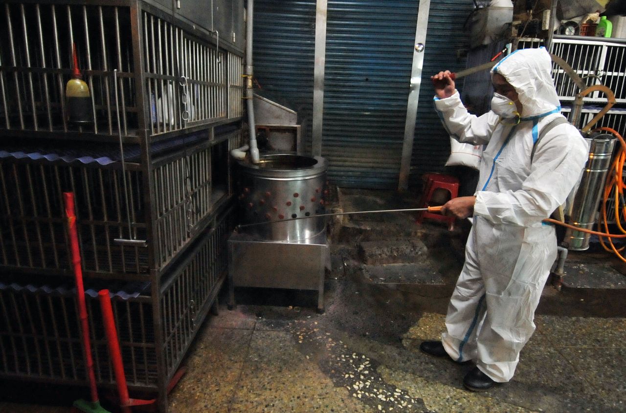 A janitor sprays disinfectant over empty chicken cages at a market in New Taipei City, Taiwan, on Monday, April 29. Asian countries have stepped up vigilance against the spread of H7N9 bird flu after a case of the deadly strain showed up in Taiwan, the first outside mainland China.