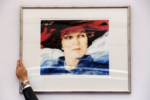 An employee removes a portrait of Beatrix in a Rotterdam courtroom on April 26, ahead of her abdication.