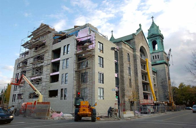 The Saint-Jean de la Croix church in Montreal, Quebec, undergoes major renovations in 2003 after being sold to be converted into condos. Many such buildings are for sale, and buyers have been difficult to come by. Some are being demolished, while others have been converted for nonreligious purposes.