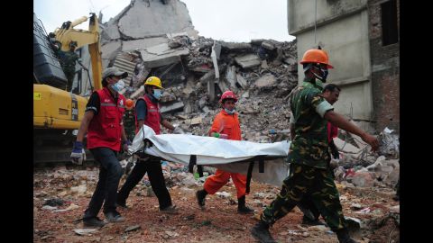 Bangladeshi troops carry the body of a garment worker out of the rubble of the collapsed Rana Plaza building in Savar on April 30.