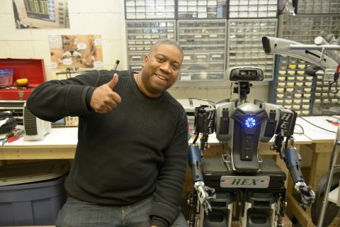 Former Baltimore cop, Mark Haygood and his robot HEX, which he made by recycling electrical equipment. 