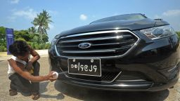 A worker polishes a Ford during an event by US carmaker Ford in Yangon on April 30, 2013.