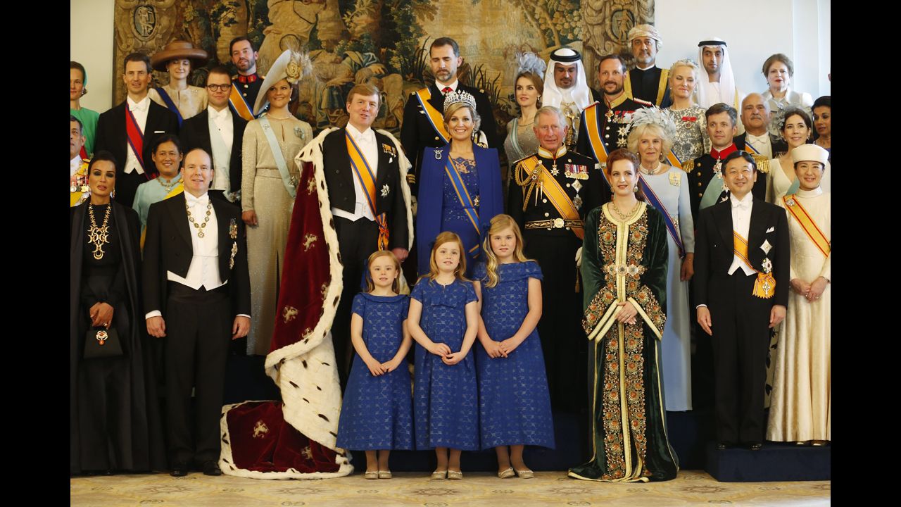 King Willem-Alexander and Queen Maxima pose with guests following their investiture ceremony.