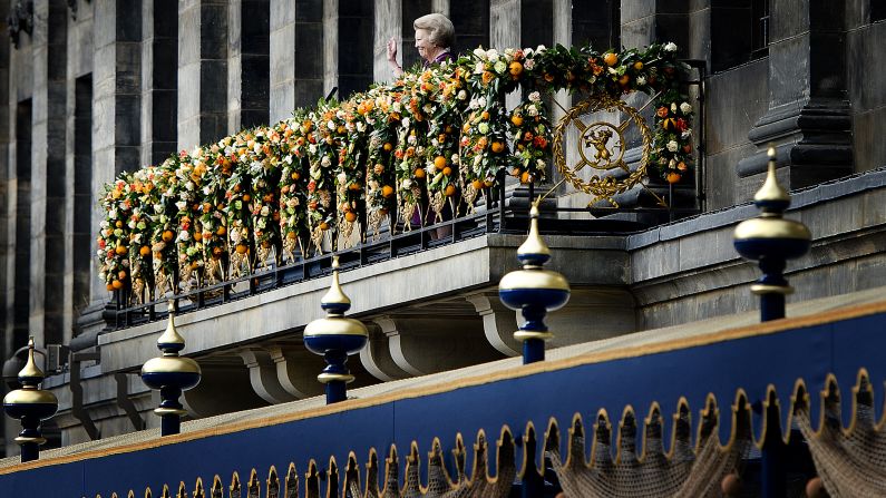 Princess Beatrix waves to the crowd gathered on Dam Square from the balcony of the Royal Palace, following the official abdication ceremony.