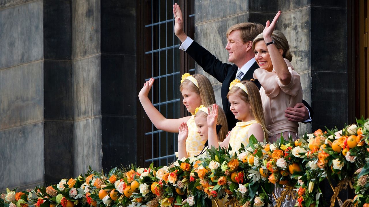 King Willem-Alexander, Queen Maxima and their children, left to right, Catharina-Amalia, Princess of Orange, Princess Alexia, and Princess Ariane wave to the crowd gathered on Dam Square.