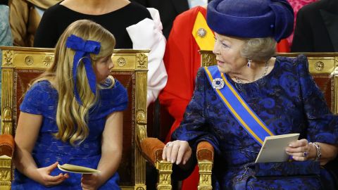 Princess Beatrix sits with her grandaughter Catharina-Amalia, Princess of Orange, during the investiture ceremony.