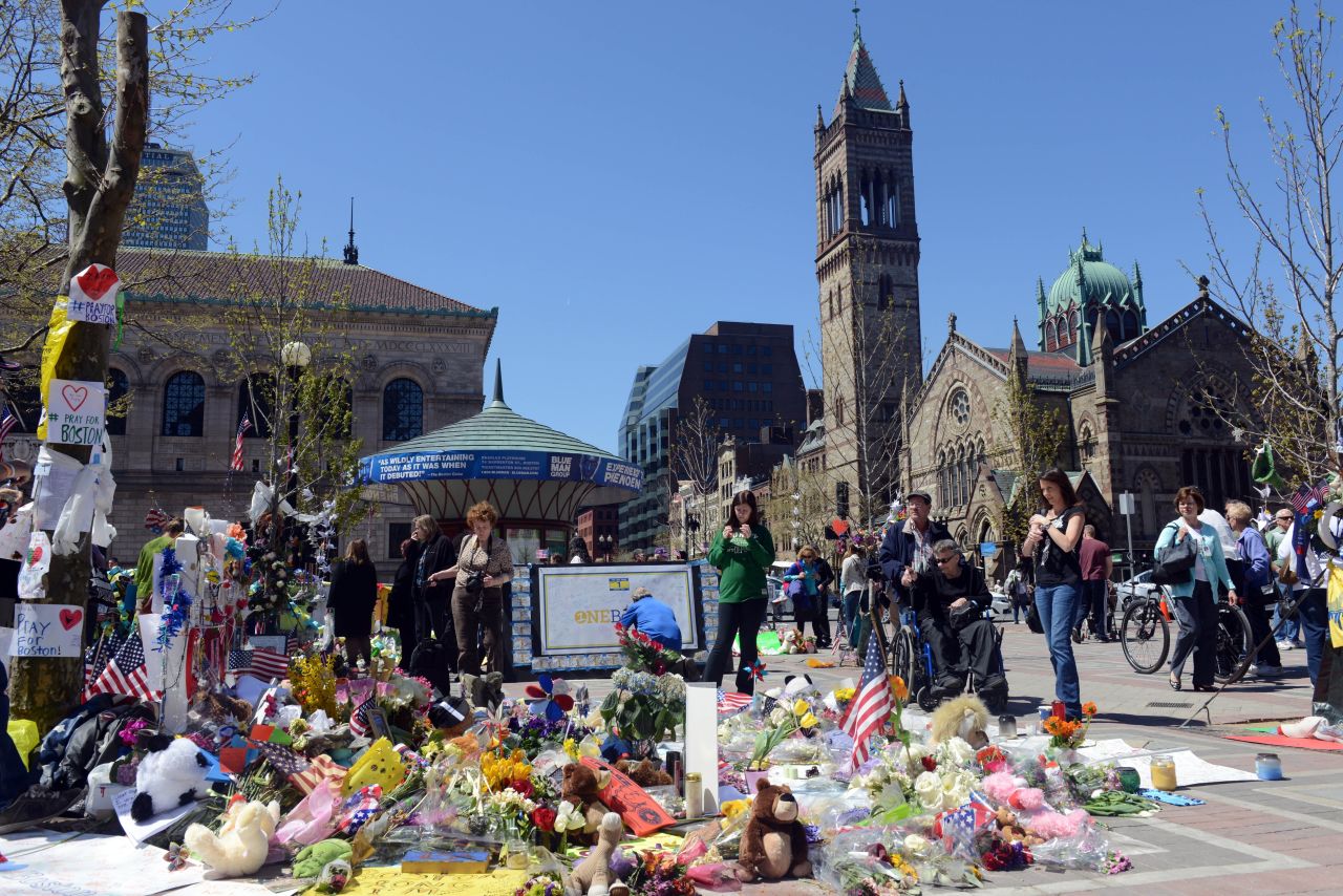 People pause at the memorial site in Boston's Copley Square on April 30, 2013.
