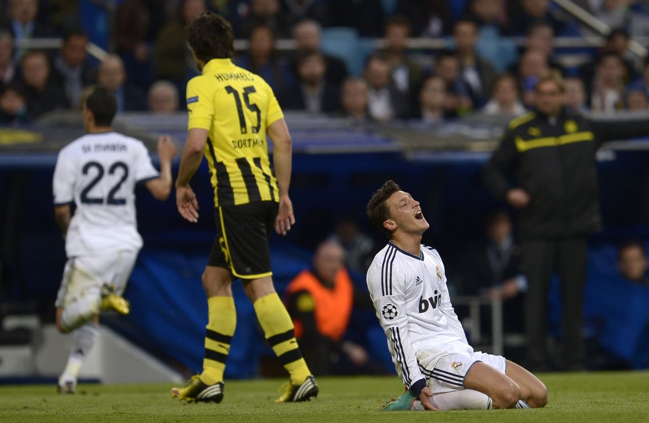 Mesut Ozil reacts after missing a glorious opportunity to give Real the lead after breaking clear of the Dortmund defense only to drill his effort wide of the post.