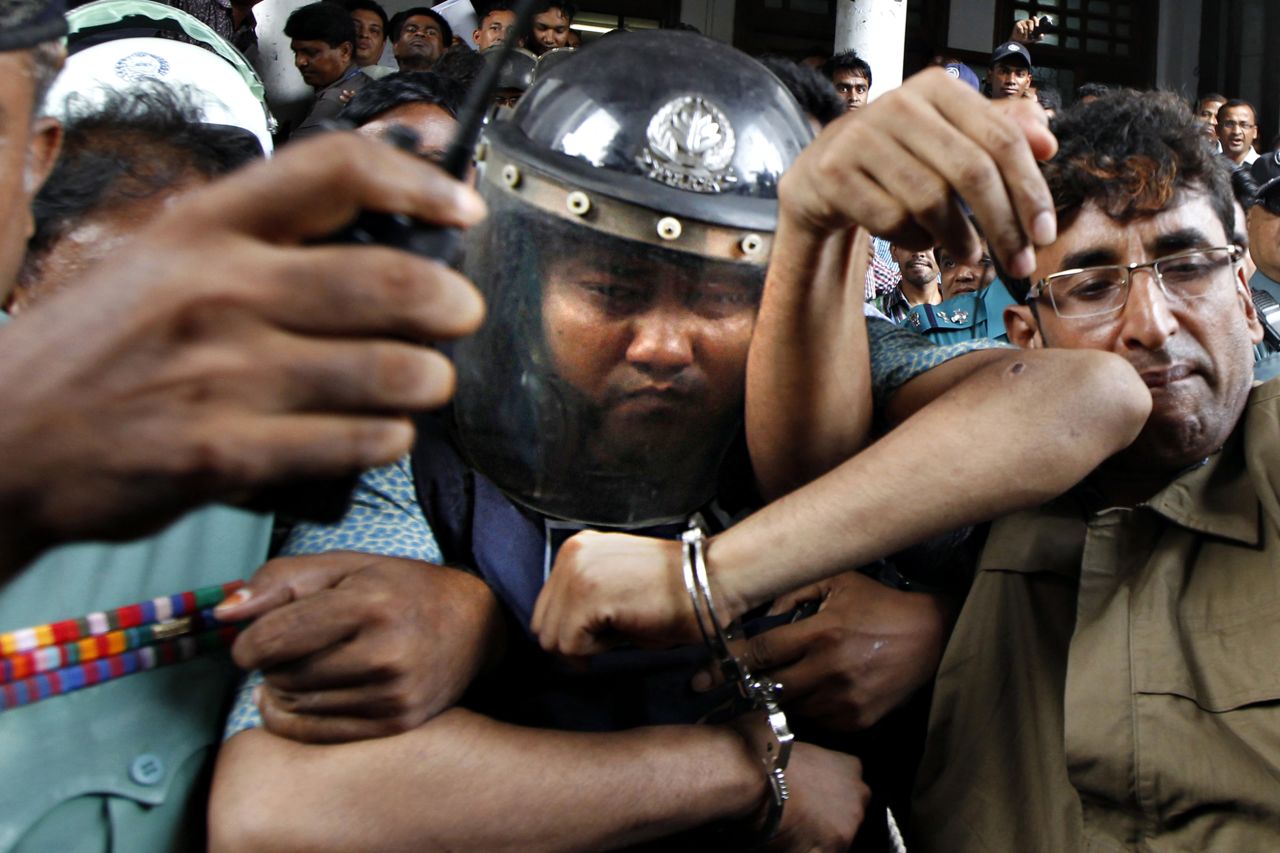 Bangladeshi property tycoon Sohel Rana, center, is escorted to the High Court in Dhaka wearing police-issued body armor as protests calling for his prosecution continue, Tuesday, April 30.