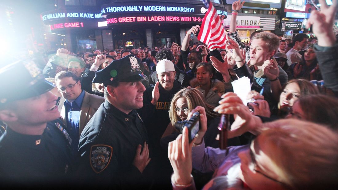 Crowds celebrate with NYPD officers in New York's Times Square early on May 2, 2011, after the death of Osama bin Laden.