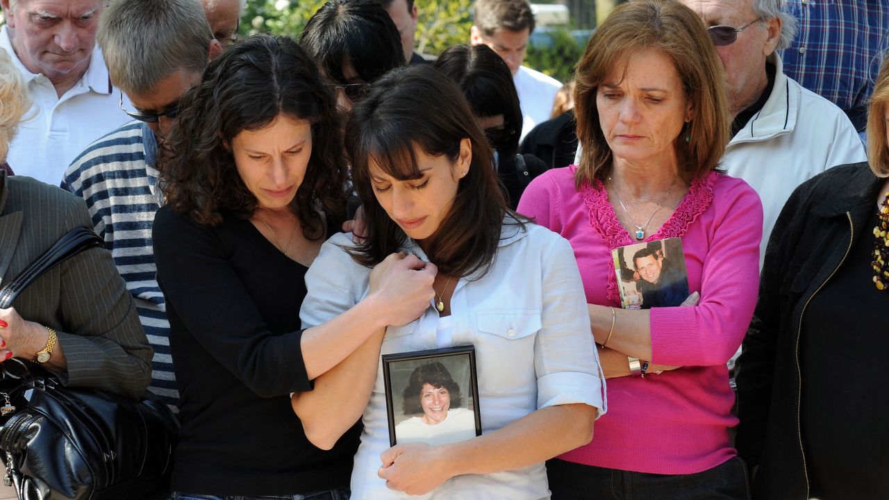 Danielle LeMack, left, Carie LeMack and Christie Coombs, who lost relatives on 9/11, pause during a ceremony to honor the victims on May 2, 2011, at the Garden of Remembrance in Boston.