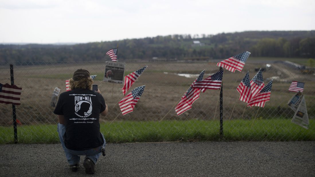 A visitor photographs the fence overlooking the crash site of Flight 93 in Shanksville, Pennsylvania, on May 2, 2011.