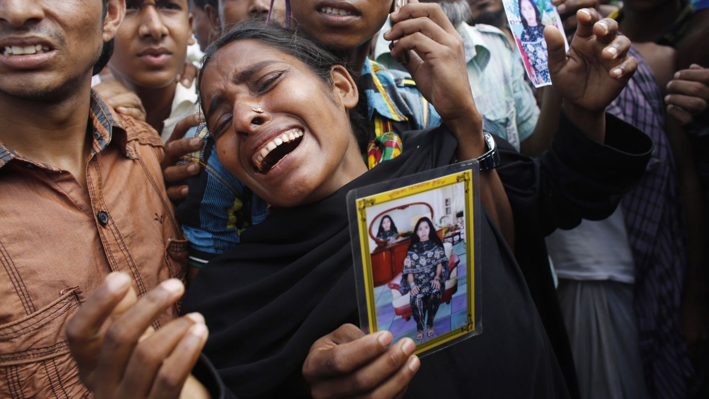A woman mourns before a mass burial in Dhaka on Wednesday, May 1.