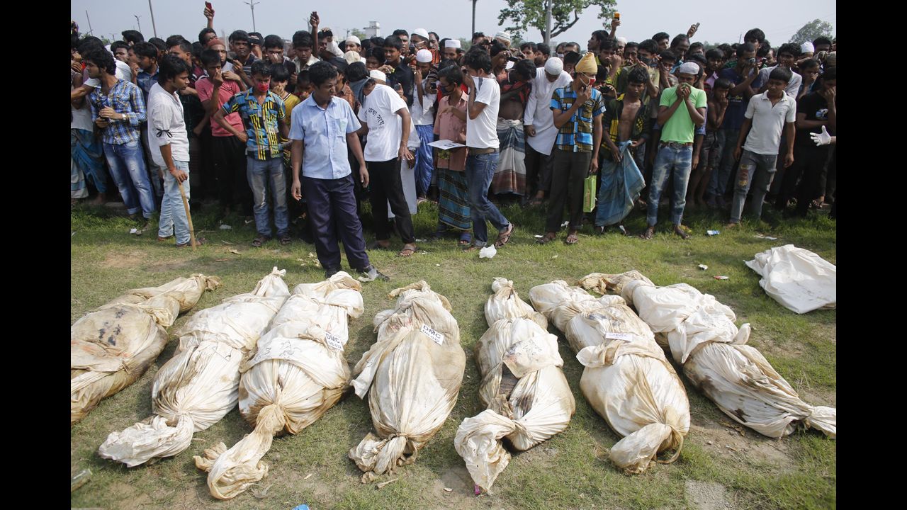 Unidentified bodies from the rubble lie on the ground as people gather for a mass burial in Dhaka on May 1.