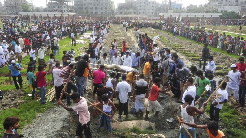 Workers dig graves during a mass burial of unidentified garment workers on May 1.