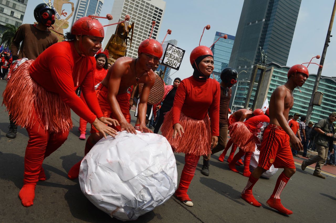 Indonesian workers wearing ant costumes to depict the exploitation of workers participate in a march to the presidential palace in Jakarta.