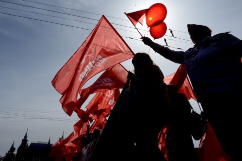 Russian communist party activists carry red flags and banners during their traditional May Day rally in Moscow.