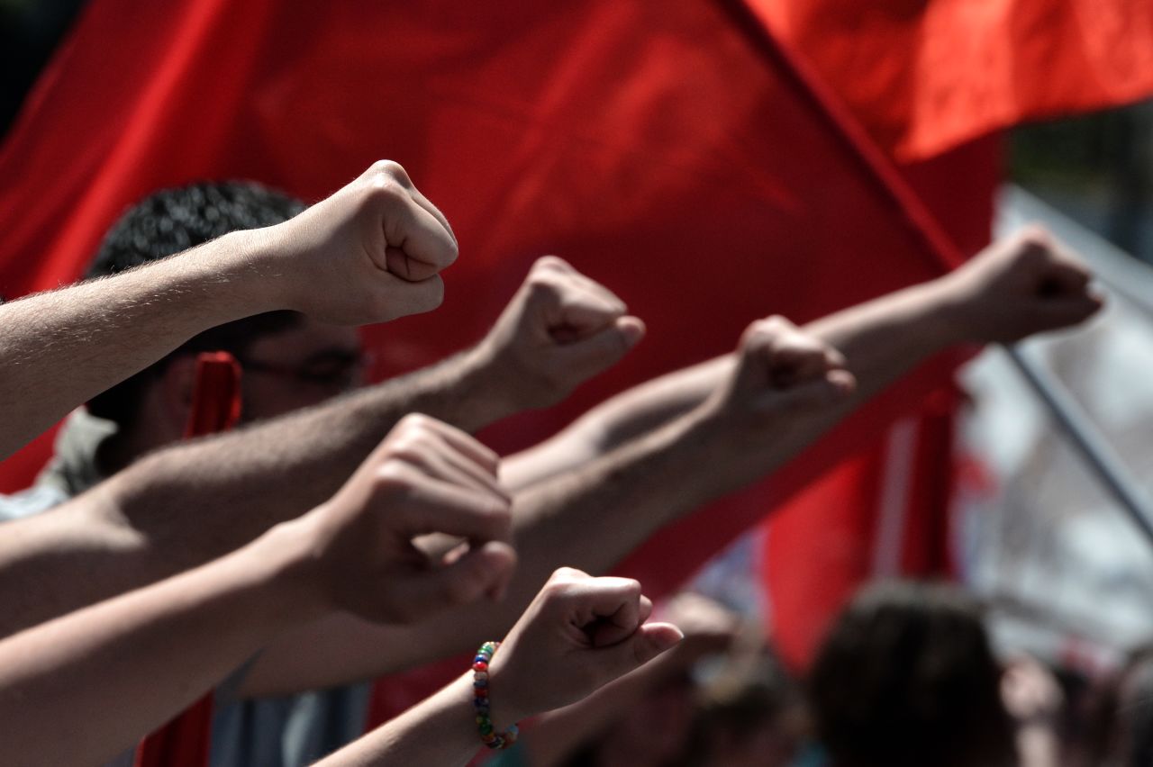 Participants raise their fists during a demonstration in Athens.