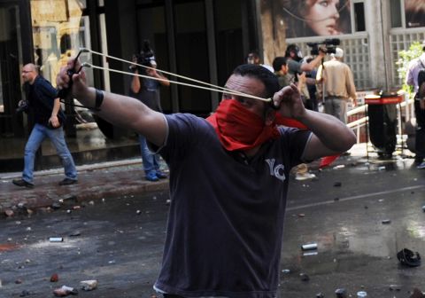 A May Day protestor uses catapults during clashes in Istanbul.