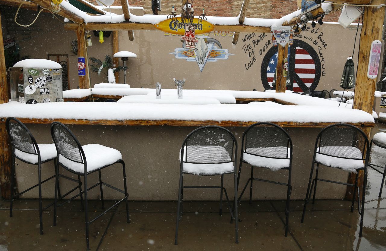 Snow covers an outdoor bar in downtown Golden, Colorado, after a spring storm dumped more than a foot of snow on Wednesday, May 1. In nearby Denver, the average date for the last snow of the season is April 26, but the record for the latest snowfall was set June 12, 1947, according to the National Weather Service.