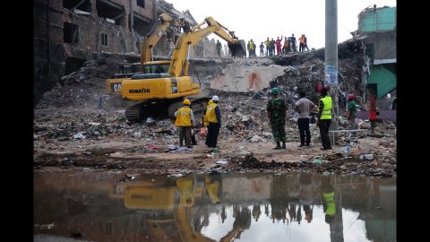 Rescue workers move debris as Bangladeshi army personnel continue the second phase of a rescue operation at the site of the collapsed building in Savar on May 2.