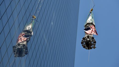 The final section of the spire is raised to the top of One World Trade Center.