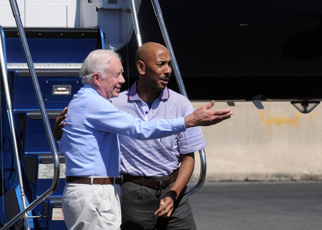 Former President Jimmy Carter and former North Korean detainee Aijalon Gomes arrive in Gomes' hometown of Boston.