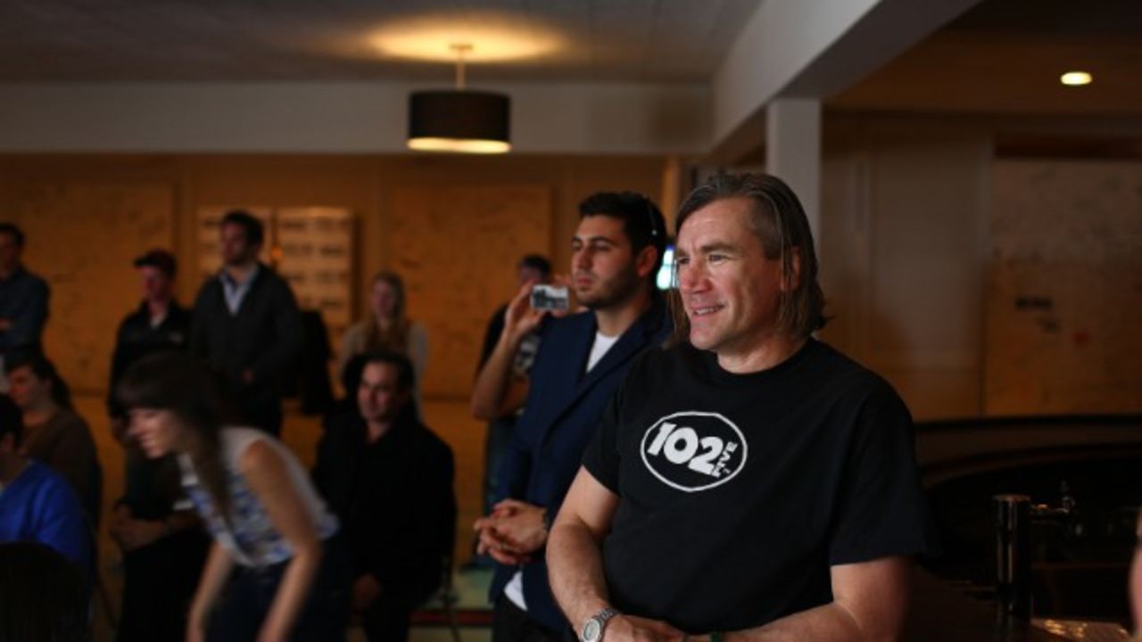 CD102.5 general manager Randy Malloy watches a band perform at the station.