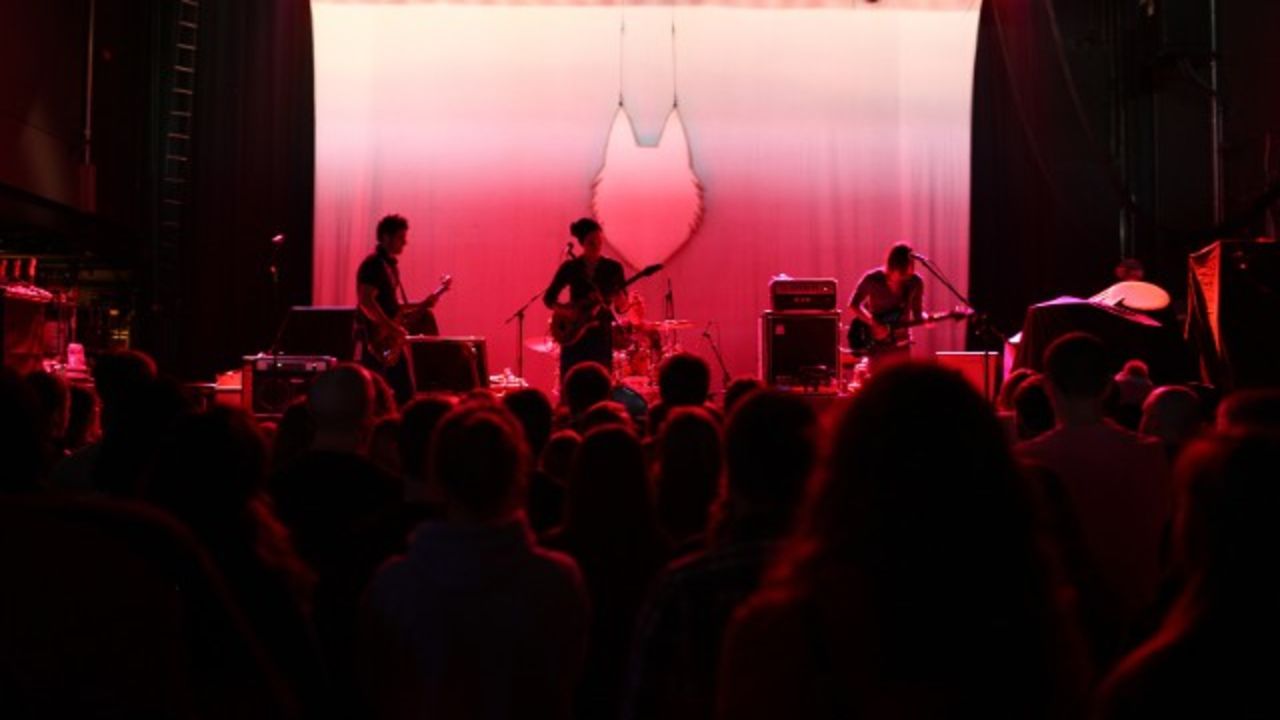 Fans watch local band Post Coma Network at a concert put on by CD102.5.