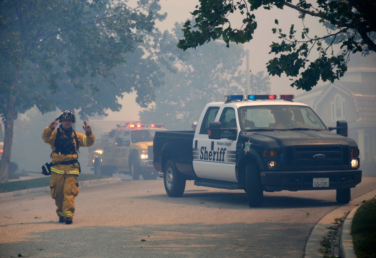 Ventura County fire and sheriffs officials deploy for structure protection as the wildfire approaches Newbury Park on Thursday. 