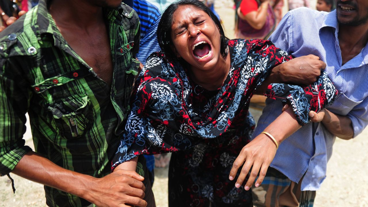 A woman reacts on May 3 after identifying a body found in the rubble.