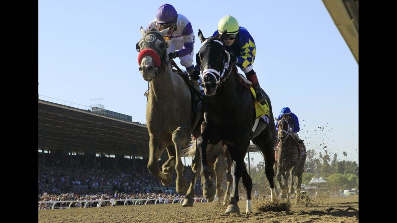 Horse Shanghai Bobby and Rosie Napravnik, right, race to first place ahead of Mario Gutierrez and He's Had Enough during the Breeders' Cup Juvenile race in Arcadia, California, on November 3.