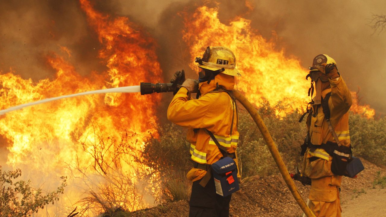 Firefighters battle a wildfire at Point Mugu State Park in California, on May 3.