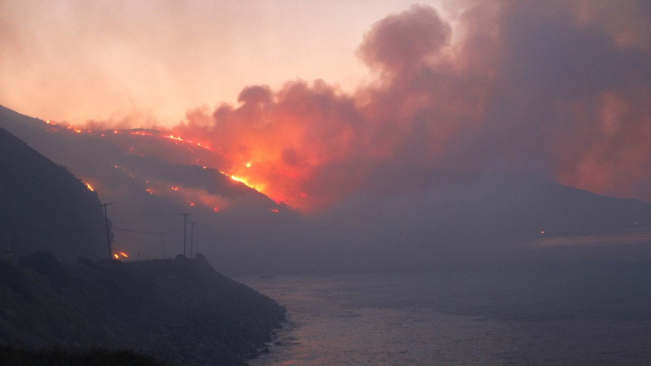 The Springs Fire burns in the early morning near the Pacific Coast Highway at Point Mugu State Park, California, on May 3.