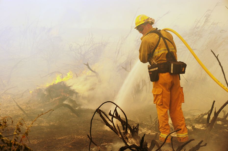 A firefighter goes after on a flareup along the Pacific Coast Highway near Point Mugu, California, on May 3.